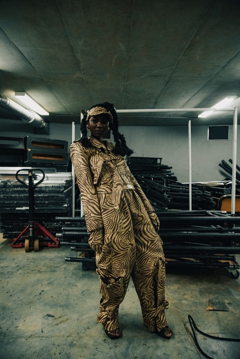 Gold patterned jumpsuit wide shot