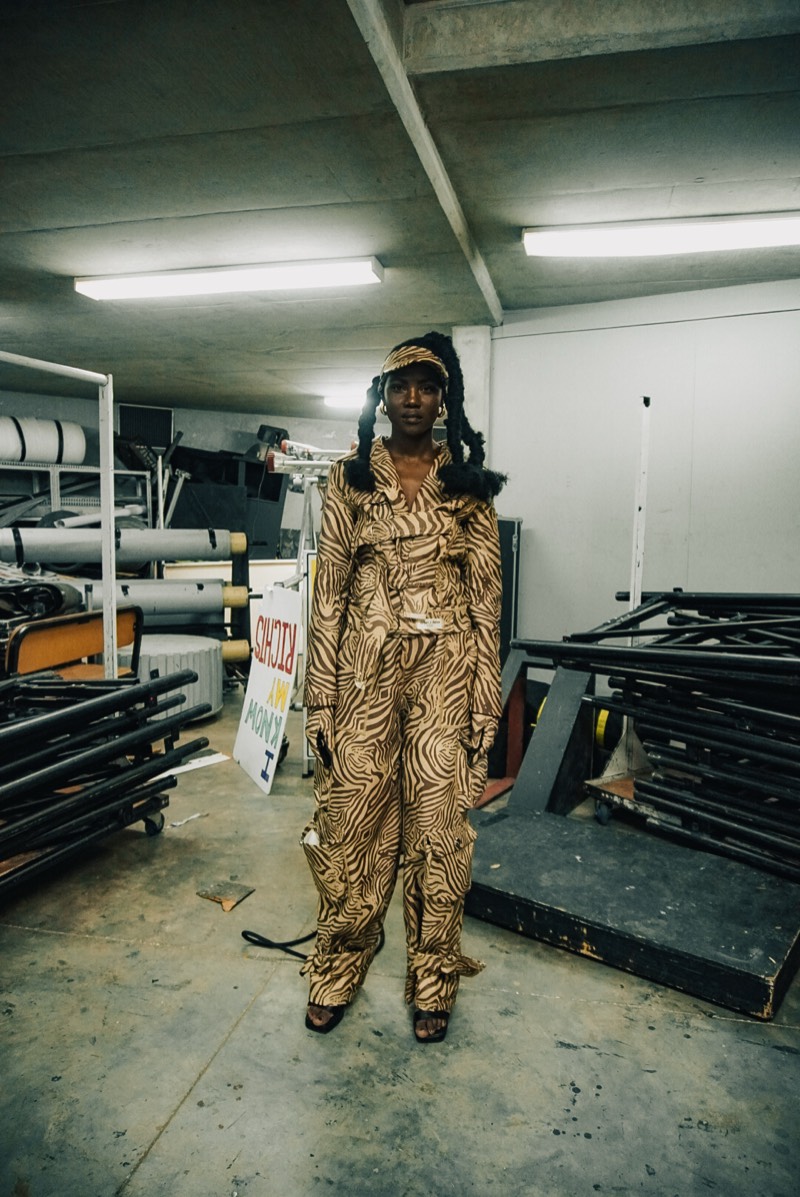 Gold patterned jumpsuit backstage