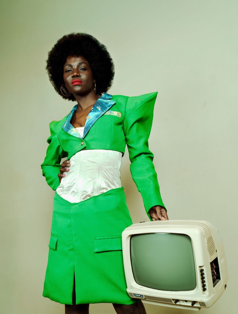 Green power suit editorial with vintage TV