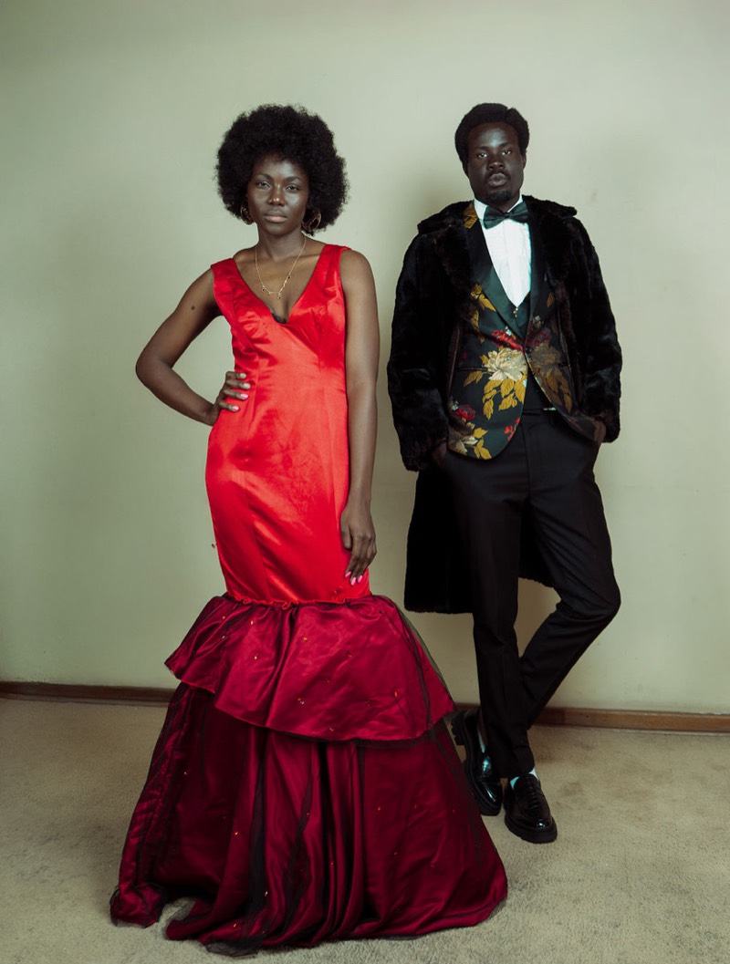 Red gown standing with male model
