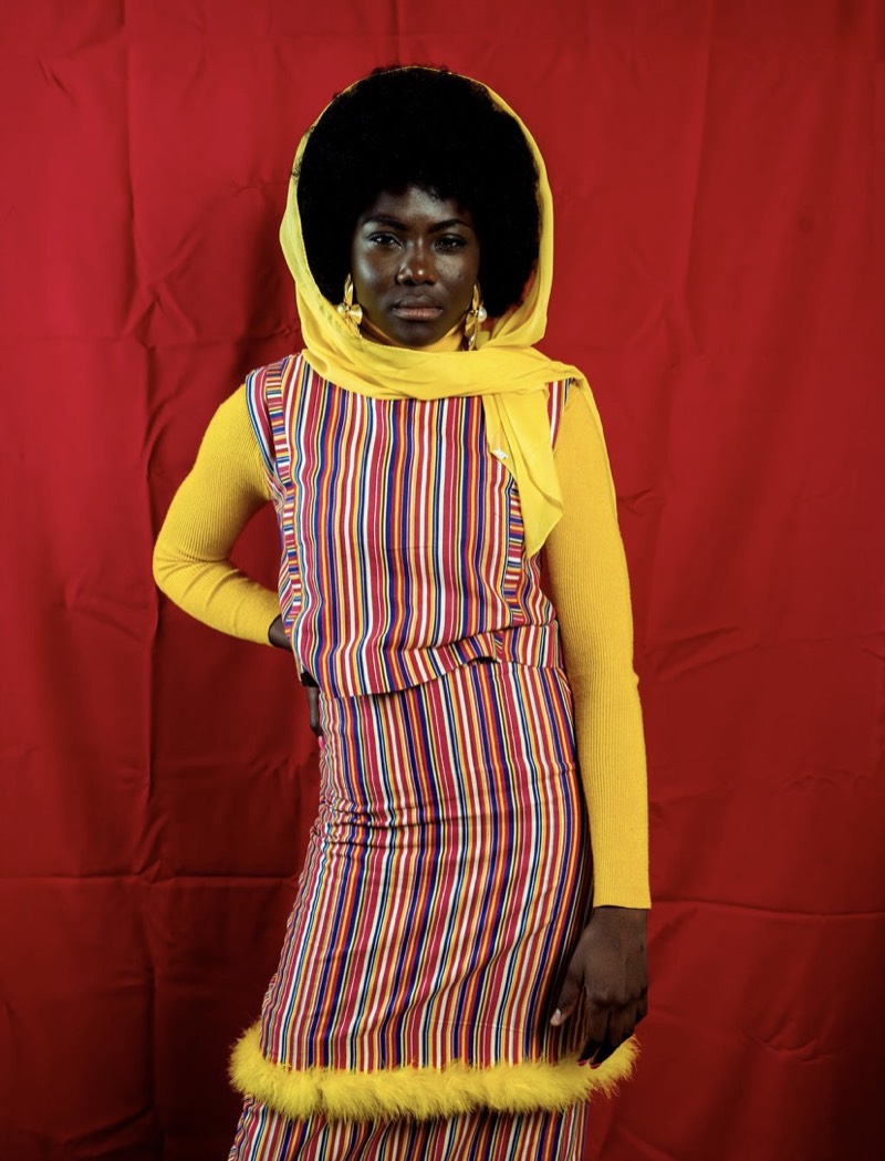 Traditional striped outfit against red backdrop